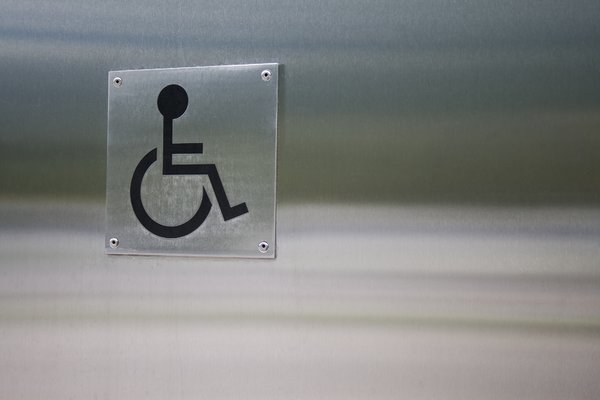 Wheelchair symbol on a silver metal wall